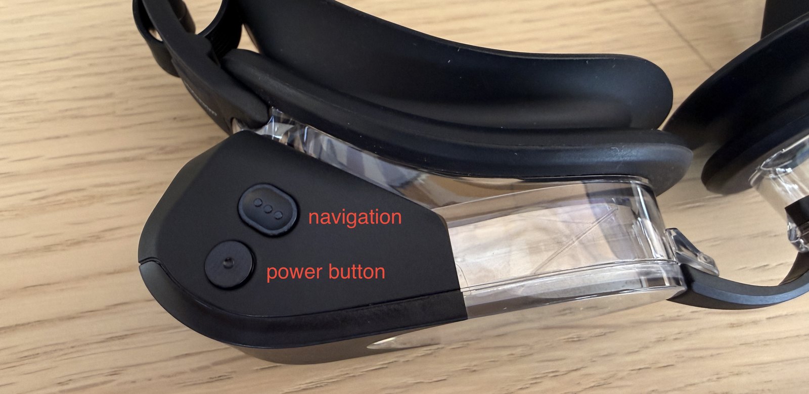 The goggle's two buttons — navigation above, power below